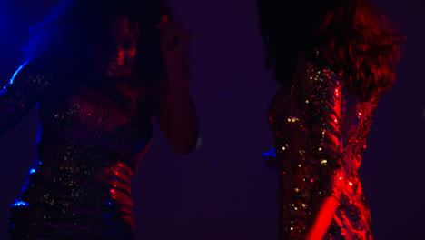 Close-Up-Of-Two-Women-In-Nightclub-Bar-Or-Disco-Dancing-With-Falling-Gold-Confetti-2